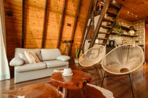 Chic and inviting living space with modern furniture and warm wooden interiors, perfect for relaxation.